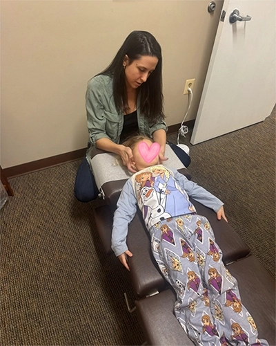 Chiropractor Baltimore MD Erin Becker Adjusting Neck